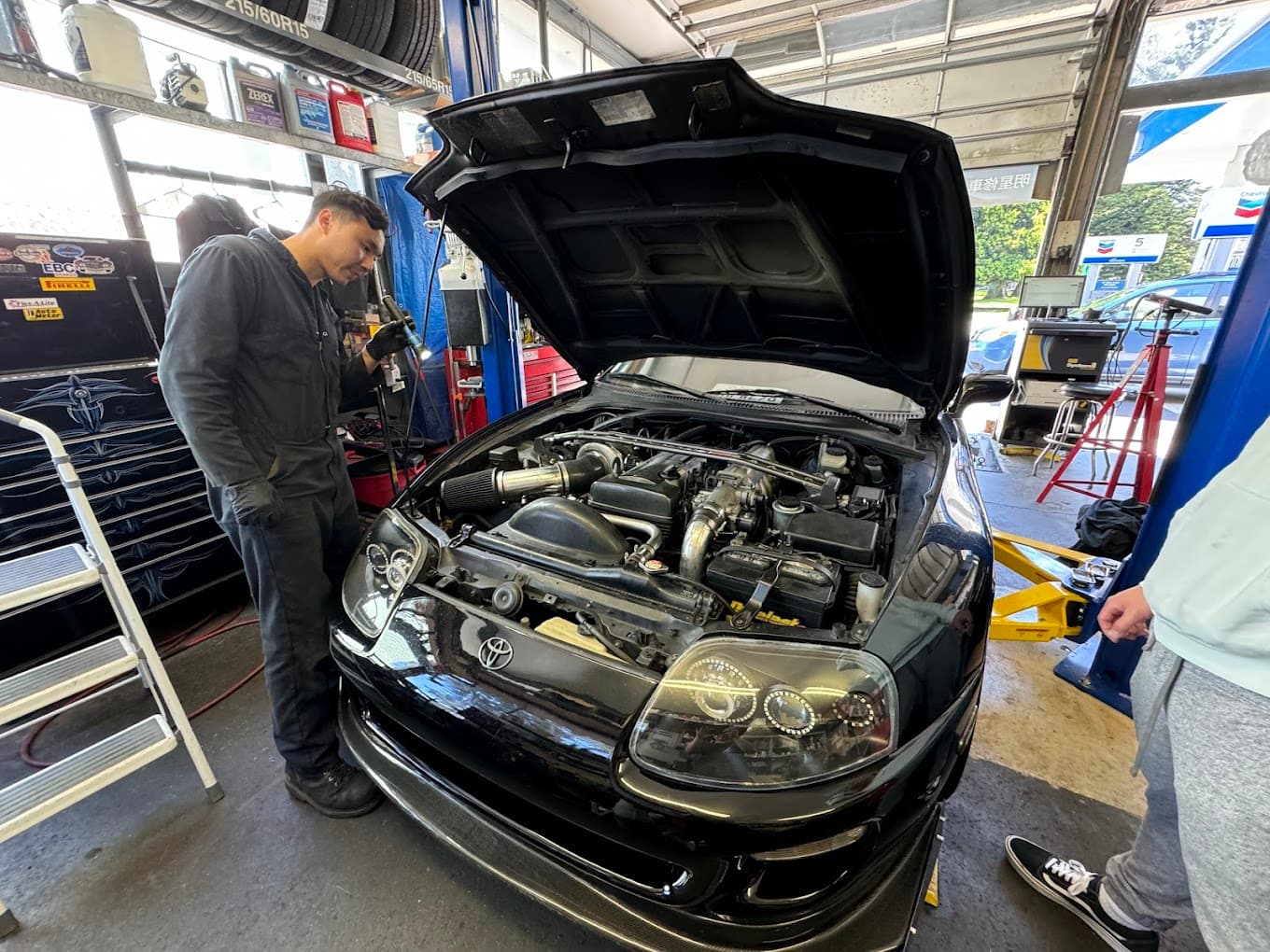 Mechanic working on a Toyota Supra at Masonic Smog & Repair